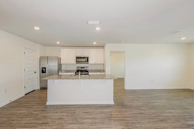 Modern kitchen with sleek stainless steel appliances at Sunset Village Apartments