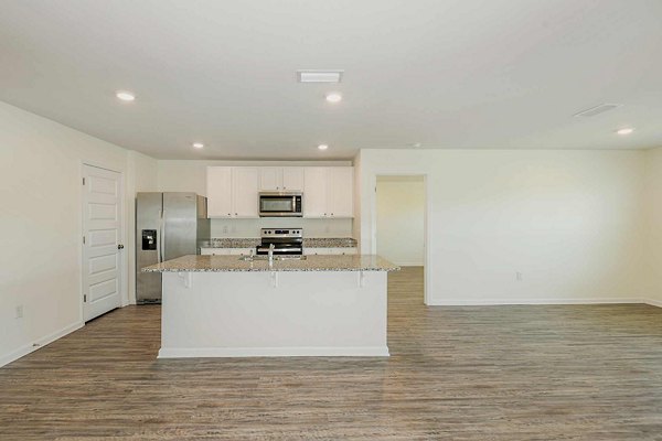 Modern kitchen with sleek stainless steel appliances at Sunset Village Apartments