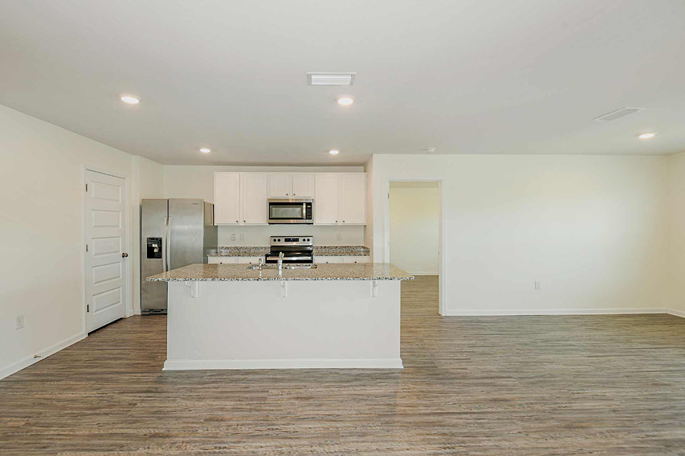 Modern kitchen with sleek stainless steel appliances at Sunset Village Apartments