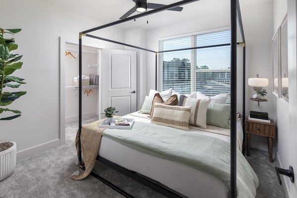 Bedroom with modern furnishings and ample natural light at Elan Brookwood Apartments