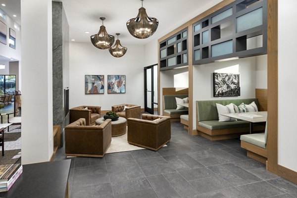 Modern clubhouse featuring chic seating and game tables at Elan Brookwood Apartments