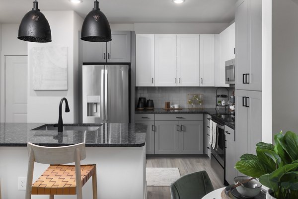 Modern kitchen featuring stainless steel appliances and quartz countertops in Elan Brookwood Apartments