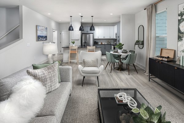 Modern living room featuring sleek furniture and large windows at Elan Brookwood Apartments