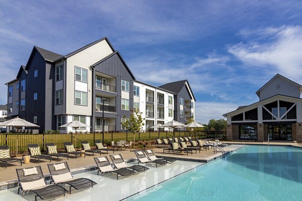 Modern outdoor pool with lounge chairs at Elan Brookwood Apartments