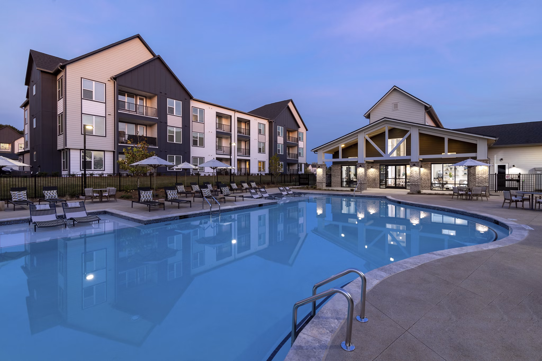 Modern pool with sun deck at Elan Brookwood Apartments offering luxury leisure amenities in an upscale community setting