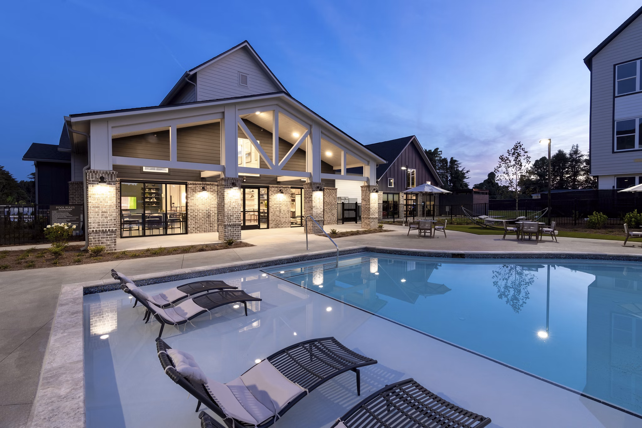 Resort-style pool with lounge chairs at Elan Brookwood Apartments