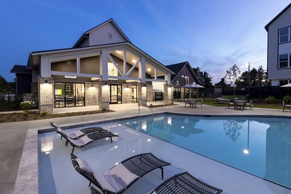 Resort-style pool with lounge chairs at Elan Brookwood Apartments