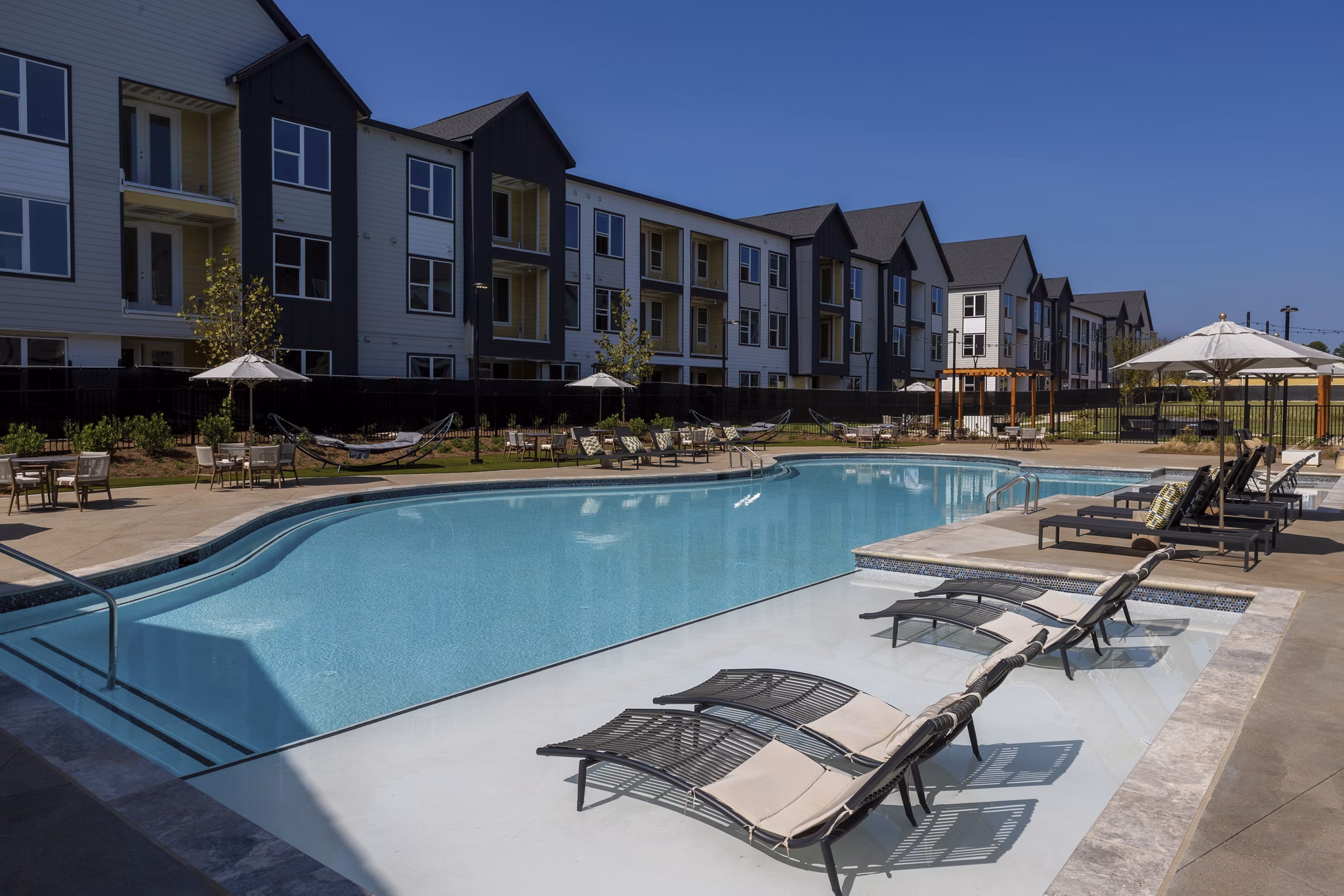 Resort-style pool with lounge chairs at Elan Brookwood Apartments, luxury living in vibrant surroundings