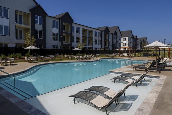 Resort-style pool with lounge chairs at Elan Brookwood Apartments, luxury living in vibrant surroundings