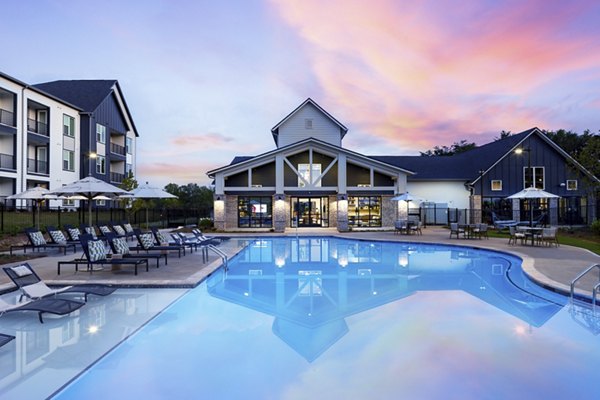Relaxing pool area at Elan Brookwood Apartments featuring luxury poolside seating