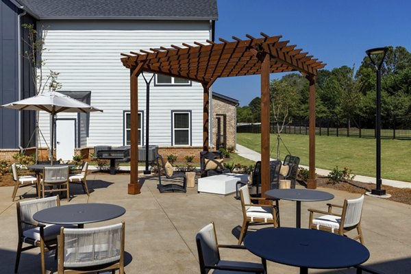 Courtyard at Elan Brookwood Apartments featuring modern outdoor seating and lush landscaping