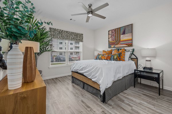 Modern bedroom with plush bedding at Coastal Exchange Apartments offering luxury living by the seaside