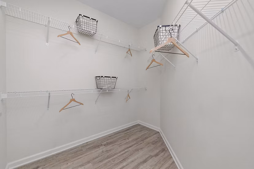 Walk-in closet with ample storage space at Coastal Exchange Apartments