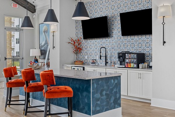 Clubhouse with modern lounge and large TV at Coastal Exchange Apartments, luxury living in the heart of Myrtle Beach.
