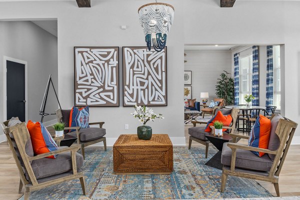 Modern clubhouse with spacious seating at Coastal Exchange Apartments, ideal for social gatherings and relaxation near the coastline
