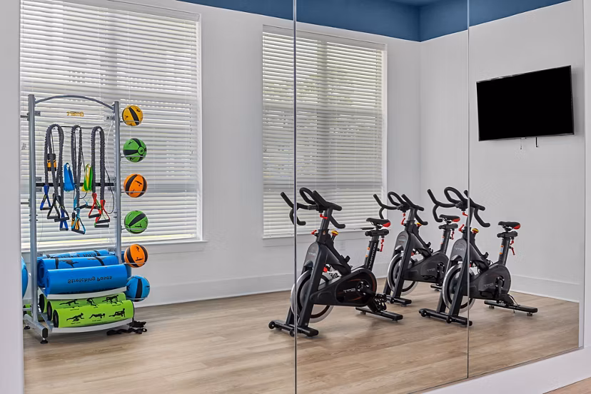 Modern fitness center with state-of-the-art equipment at Coastal Exchange Apartments