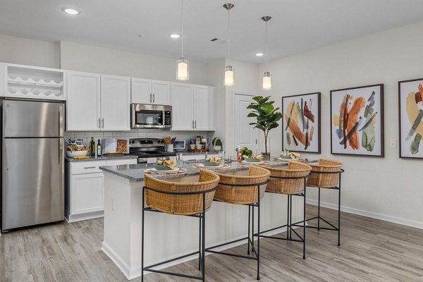 Modern kitchen featuring stainless steel appliances at Coastal Exchange Apartments