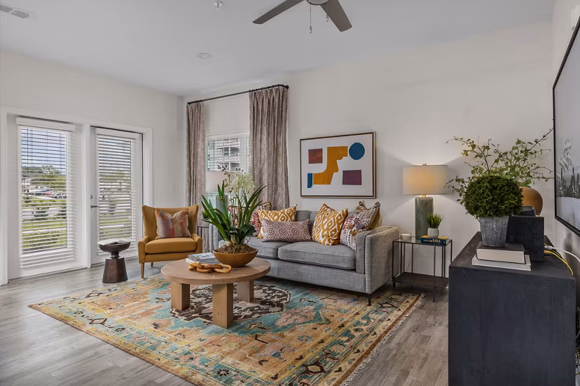 Spacious living room with modern furnishings in Coastal Exchange Apartments