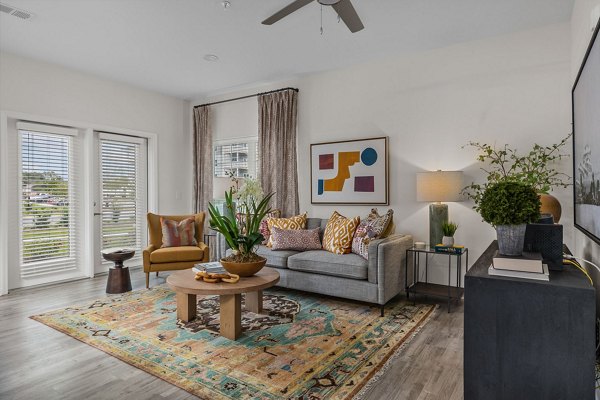 Spacious living room with modern furnishings in Coastal Exchange Apartments