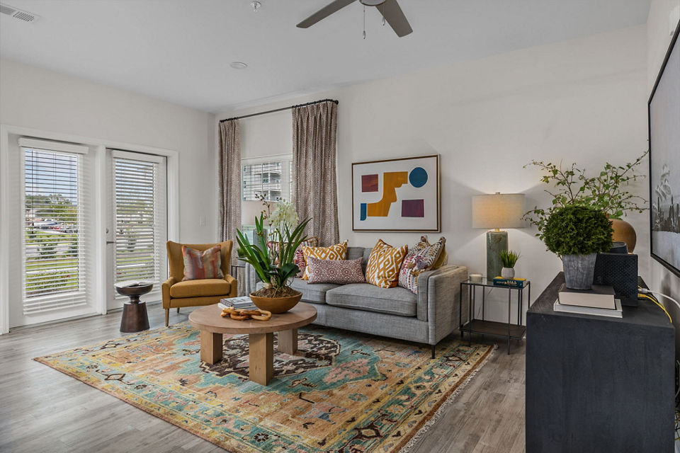 Spacious living room with modern furnishings in Coastal Exchange Apartments