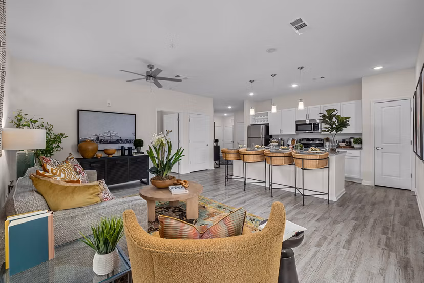 Modern living room with coastal decor at Coastal Exchange Apartments