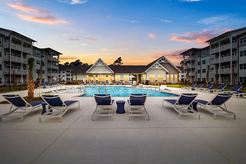 Infinity pool overlooking the ocean at Coastal Exchange Apartments, luxury living with scenic views and modern amenities