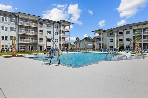 Outdoor pool area with cabanas at Coastal Exchange Apartments offering luxury amenities