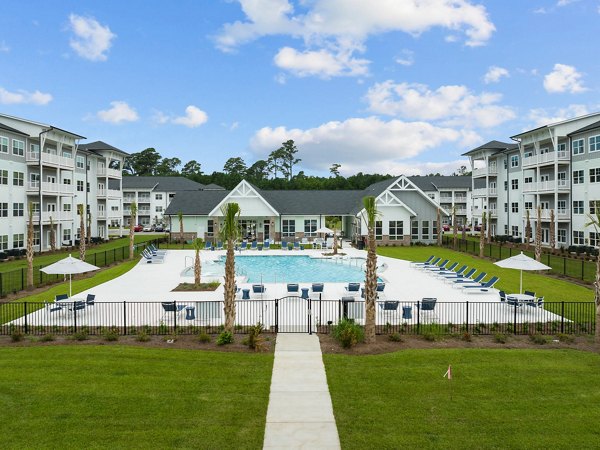 Inviting pool at Coastal Exchange Apartments with modern lounging areas, perfect for relaxation and leisure activities
