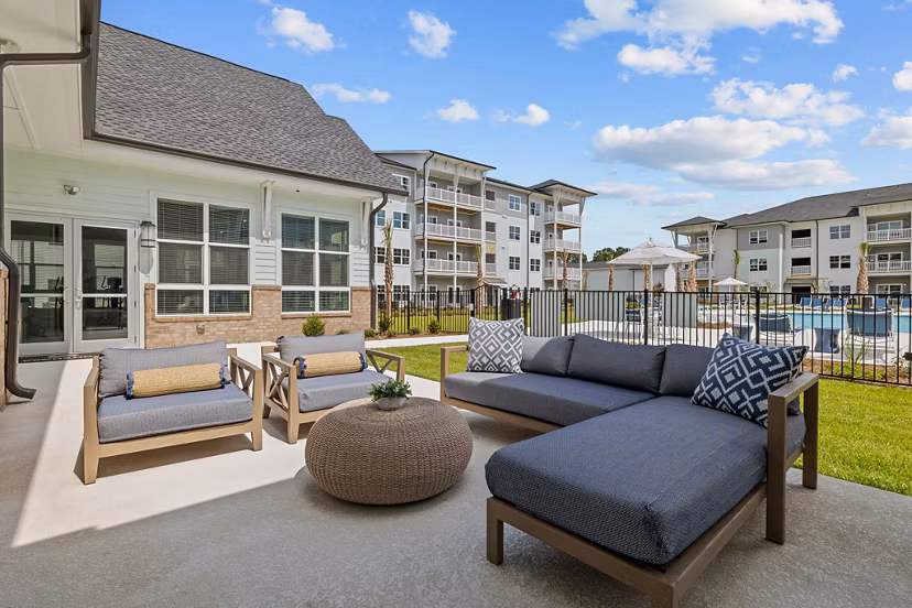 Coastal Exchange Apartments: Lush courtyard area with seating and landscaping in a luxury apartment community
