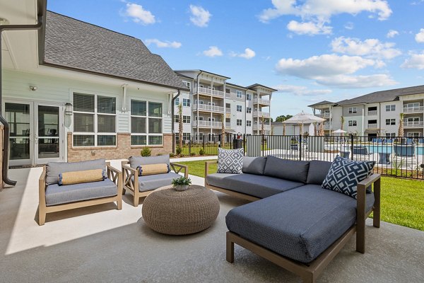 Coastal Exchange Apartments: Lush courtyard area with seating and landscaping in a luxury apartment community