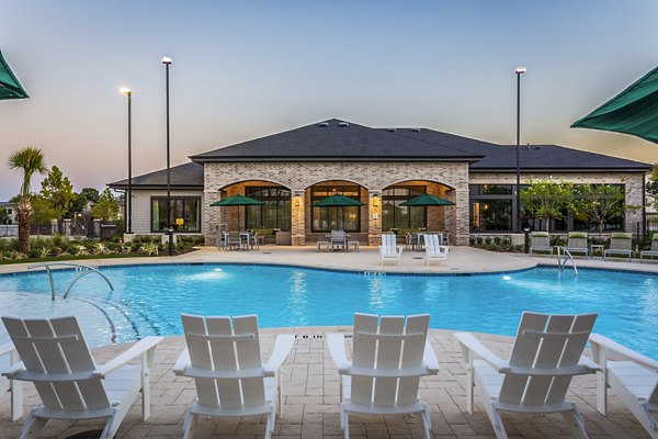 Spacious outdoor pool area surrounded by lush landscaping at Prose Vista West Apartments