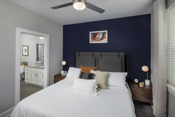 Spacious bedroom with modern furnishings at Prose Rhyne Apartments