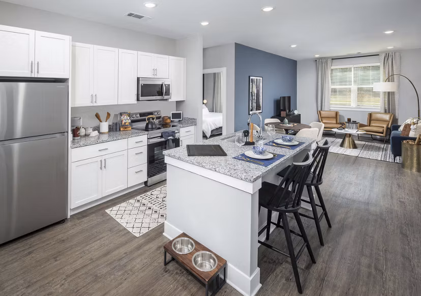 Modern kitchen with sleek countertops and stainless steel appliances at Prose Rhyne Apartments
