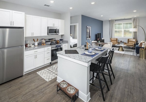 Modern kitchen with sleek countertops and stainless steel appliances at Prose Rhyne Apartments