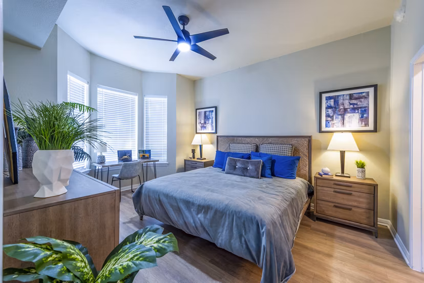 Bedroom featuring modern decor and large windows at 4001 Midtown Apartments
