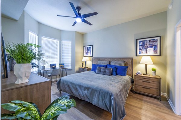 Bedroom featuring modern decor and large windows at 4001 Midtown Apartments