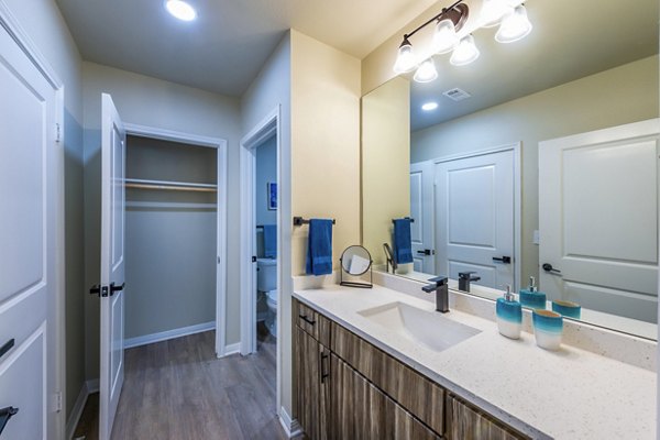 Modern bathroom featuring marble countertops at 4001 Midtown Apartments