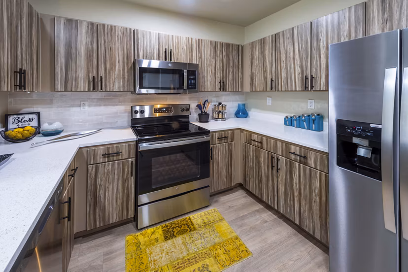 Kitchen with stainless steel appliances and granite countertops at 4001 Midtown Apartments