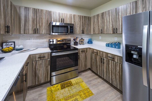 Kitchen with stainless steel appliances and granite countertops at 4001 Midtown Apartments