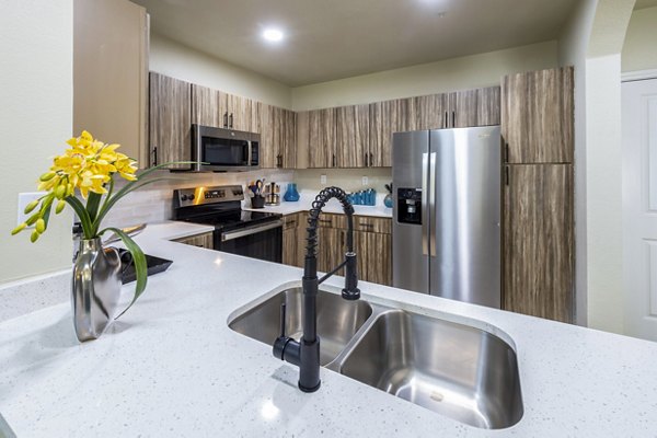 Kitchens with granite countertops and stainless steel appliances at 4001 Midtown Apartments