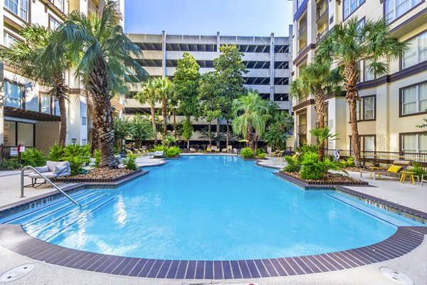 Refreshing pool at 4001 Midtown Apartments with comfortable lounge chairs and lush greenery