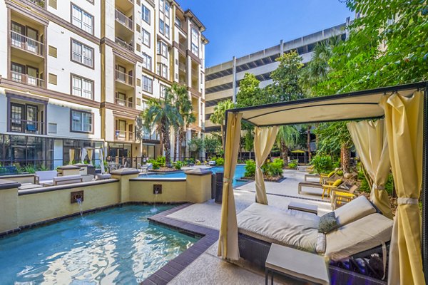 Resort-style pool surrounded by lush greenery at 4001 Midtown Apartments, offering a luxurious relaxation space for residents