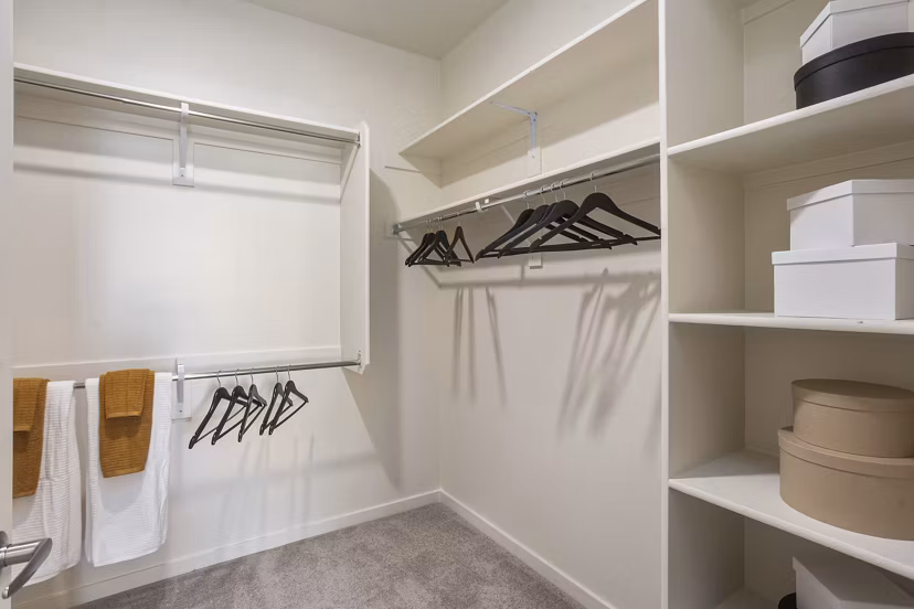 Walk-in closet with ample shelving at Prose Desert River Apartments, luxury rental by Greystar