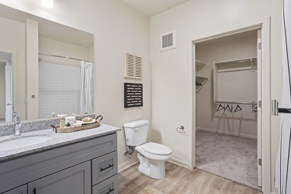 Bathroom with sleek fixtures and granite countertops at Prose Desert River Apartments