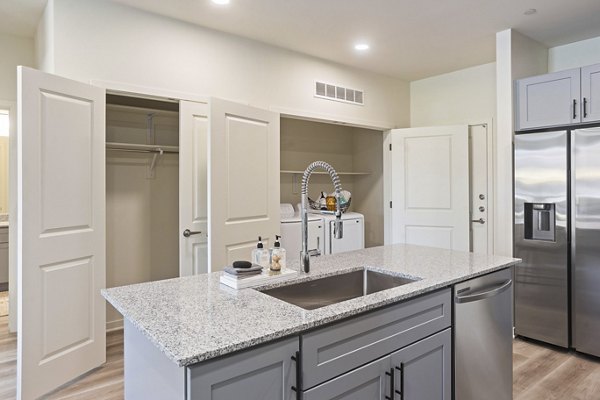 Modern kitchen with sleek countertops and stainless steel appliances in Prose Desert River Apartments