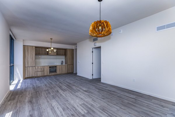 Modern living room with large windows and stylish decor at Metro Edgewater Apartments