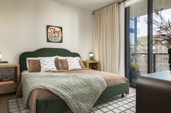 Elegant bedroom with modern furnishings at The Waller Apartments