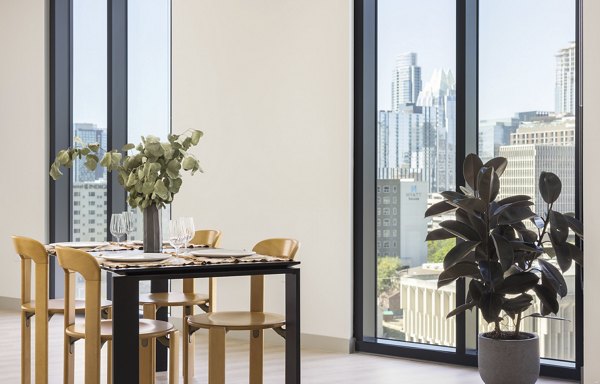 Dining area with elegant decor and modern lighting at The Waller Apartments