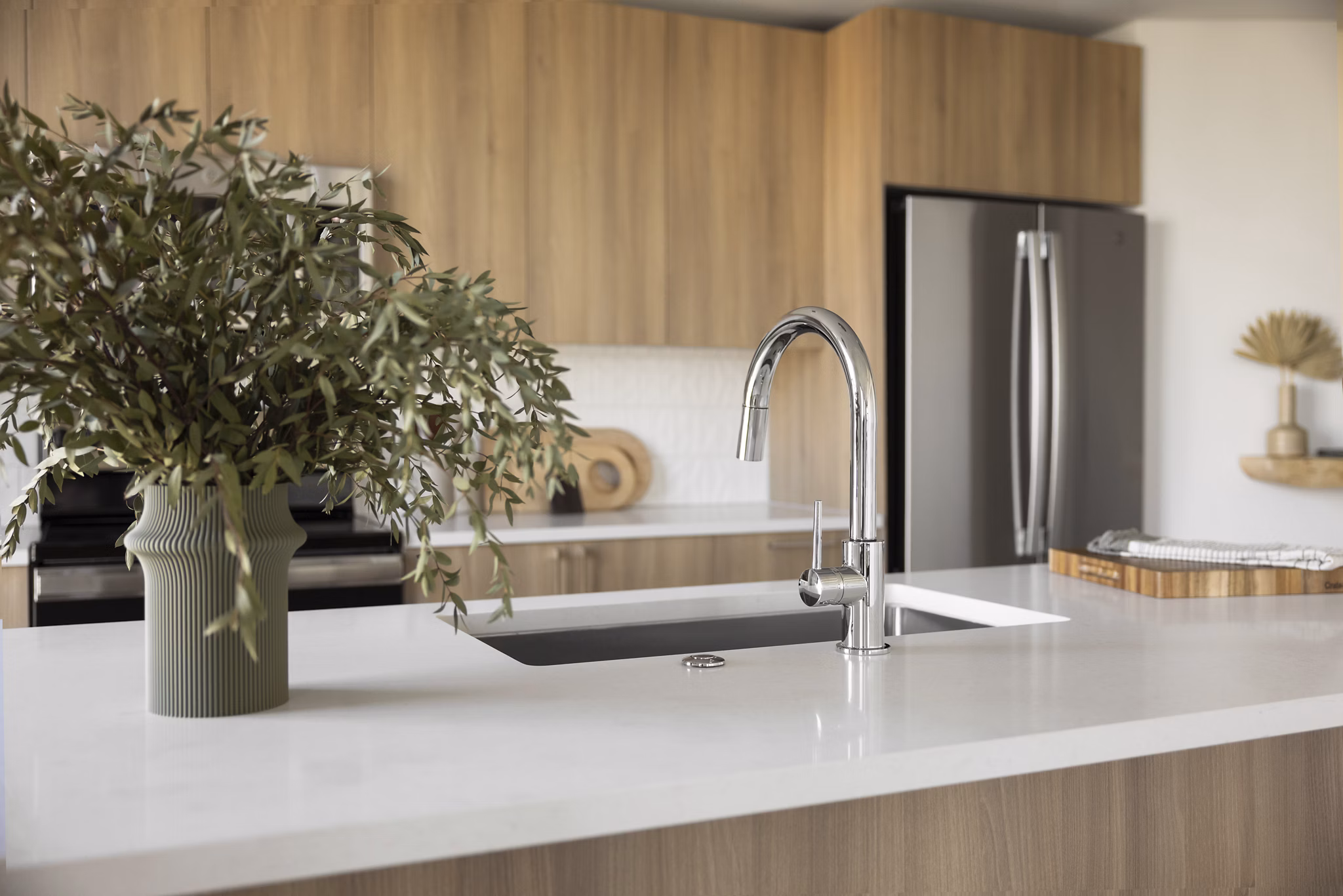 Modern kitchen with sleek cabinetry and stainless steel appliances at The Waller Apartments, offering luxurious living in a Greystar community