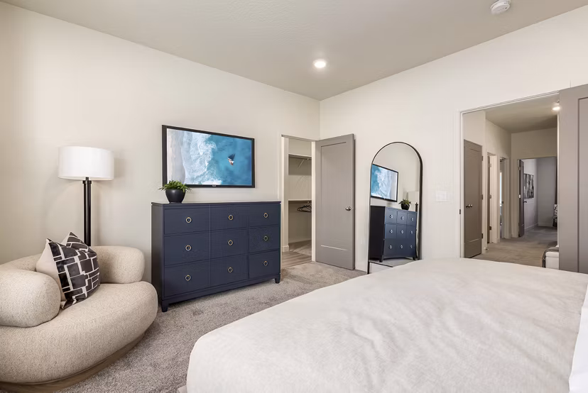 Cozy bedroom with modern furniture at H2O Townhomes Apartments